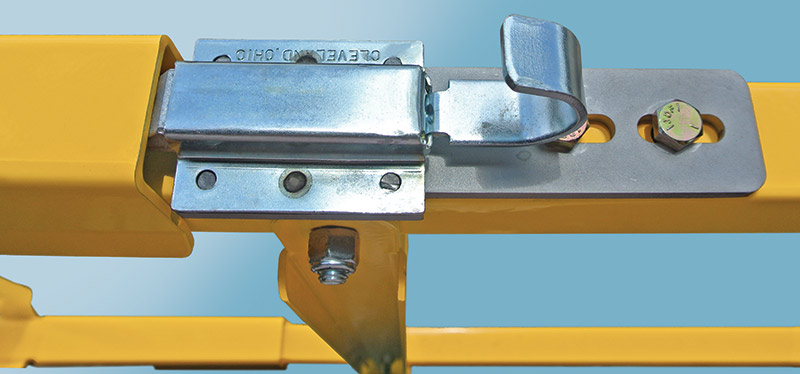 DVG Series low clearance loading dock safety gates with close-up of the gate's locking latch